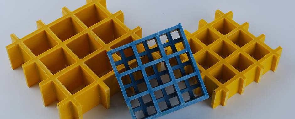 FRP grating in yellow and blue color with large holes and small holes.